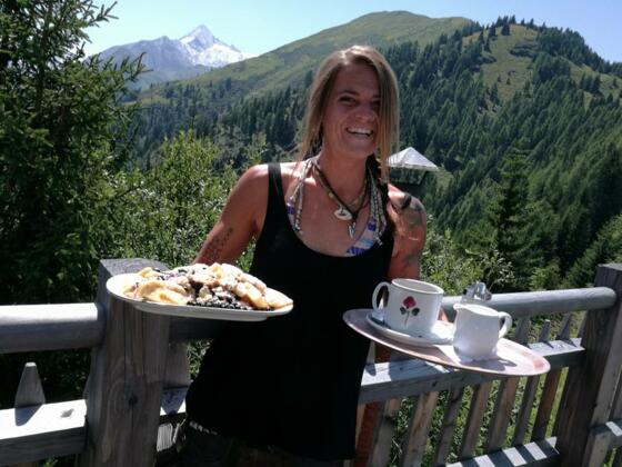 Wirtin mit Kaiserschmarren mit frischen Heidelbeeren