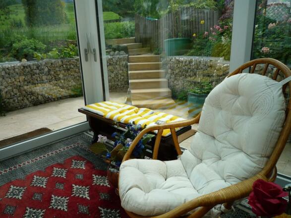 Wintergarten mit Schaukelstuhl