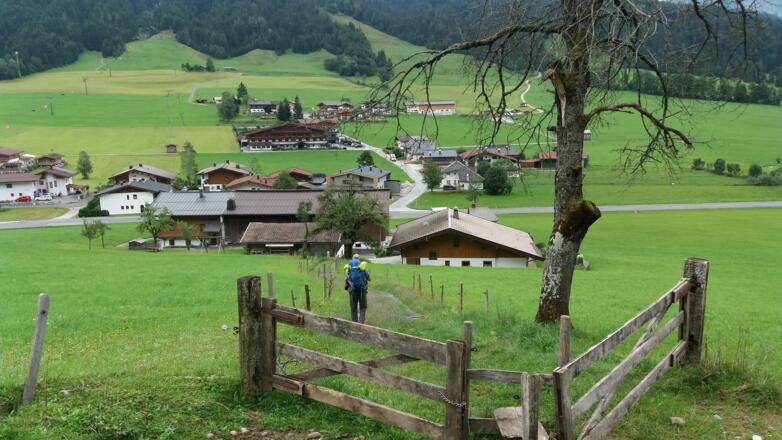 Hinter dem ersten Gebäude schaut bereits das Dach der Kapelle hervor.