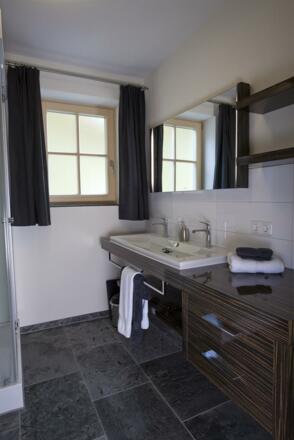 Das Bad im Erdgeschoss mit Dusche, Waschtisch, WC