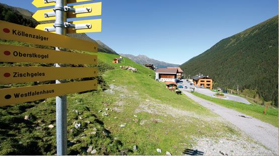 Wegweiser in Praxmar. Hintergrund Gasthof Praxmar