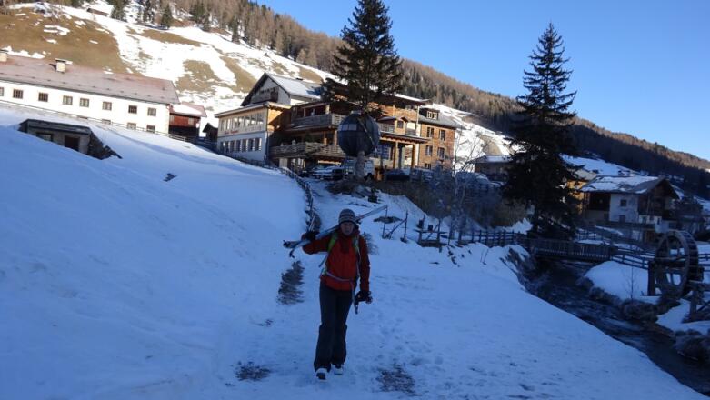 Ein paar Meter Ski tragen, hinten Almi&#039;s Berghotel (Parkplatz).